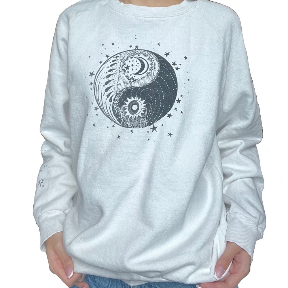 White crew neck with black designs on chest and sleeve. Size small, H&M